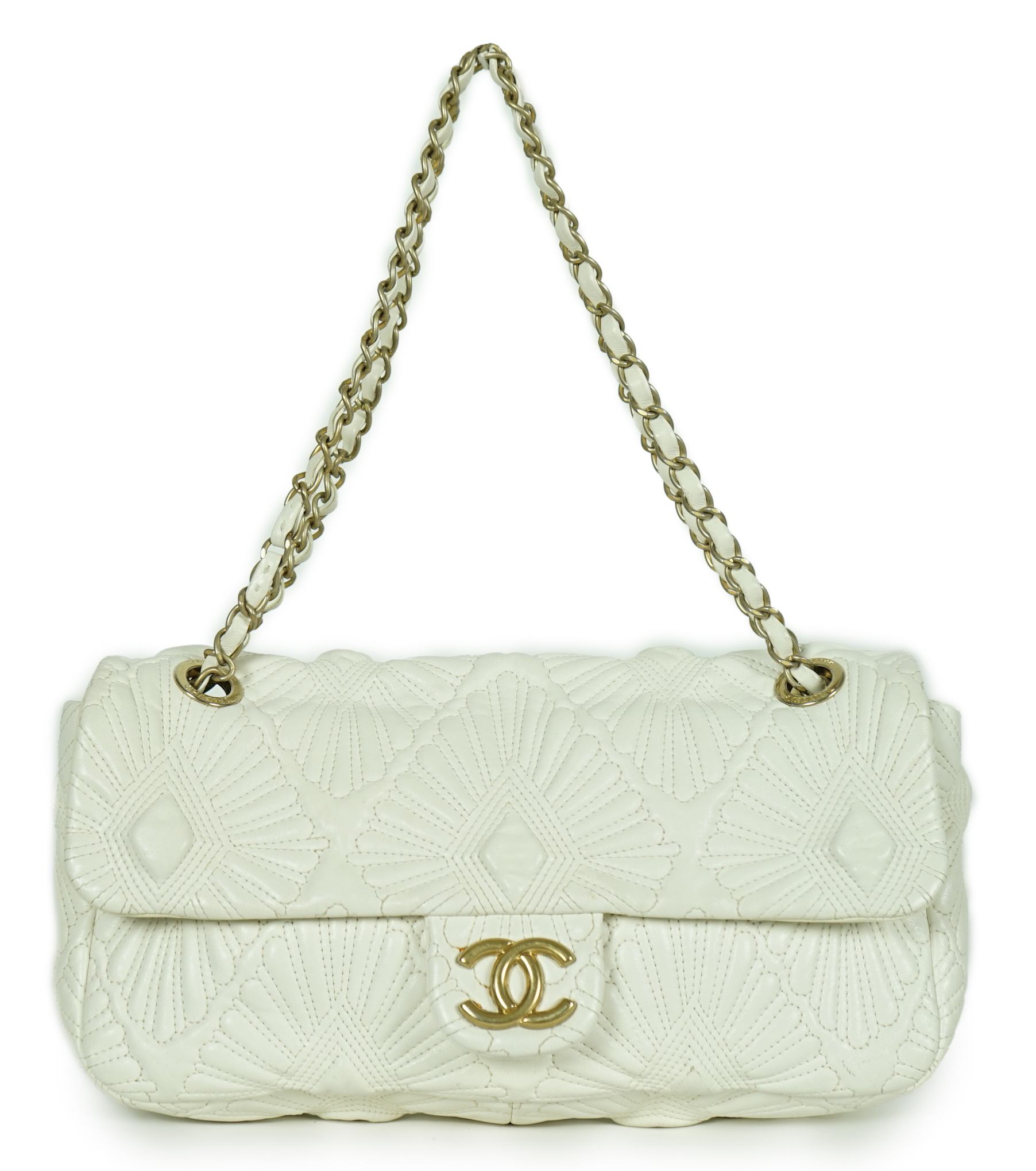 A white quilted Chanel shoulder bag, with maker’s dust bag, height 17cm, overall height 37cm, width 30cm, depth 7cm, Please note this lot attracts an additional import tax of 20% on the hammer price